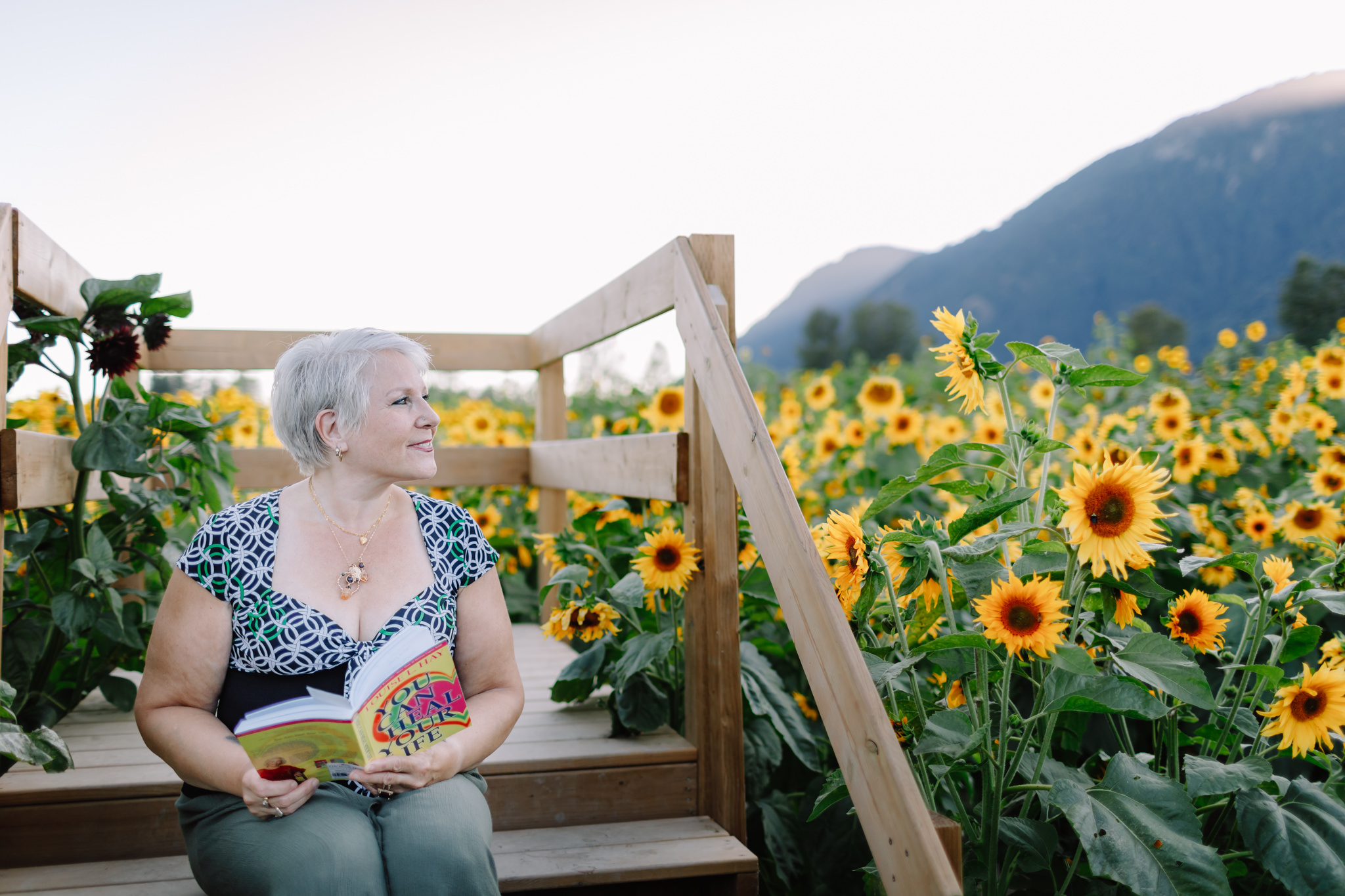 personal branding photography woman reading in sunflower field